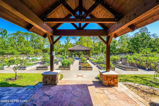 view of patio / terrace featuring a gazebo, fence, and a garden