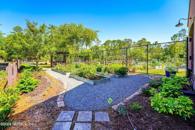 view of yard with fence and a vegetable garden