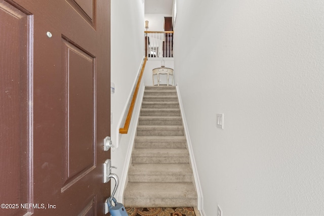 staircase featuring baseboards