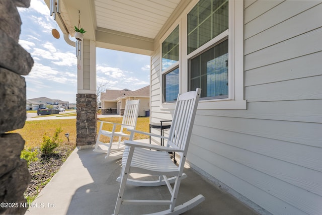 view of patio / terrace with a porch and a residential view