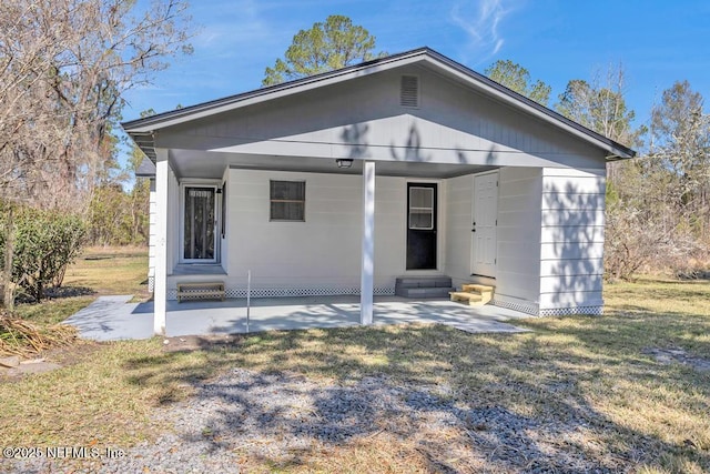 bungalow with a patio area, entry steps, and a front yard