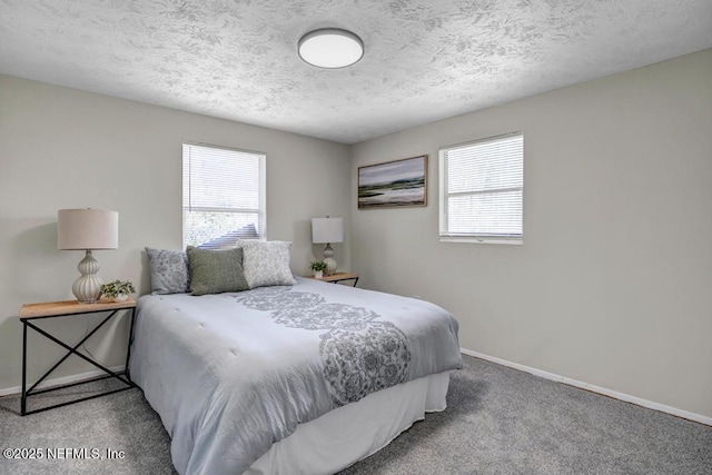 carpeted bedroom featuring multiple windows, baseboards, and a textured ceiling