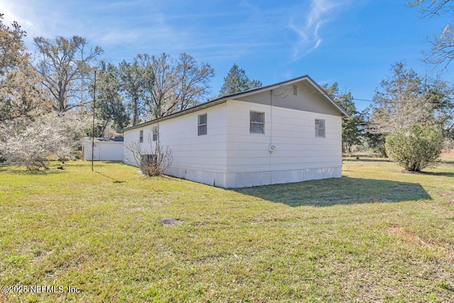 view of property exterior featuring a lawn