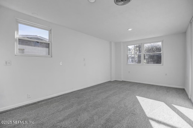 carpeted empty room with recessed lighting, visible vents, and baseboards