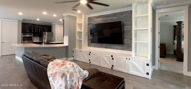 living area with recessed lighting, crown molding, and ceiling fan