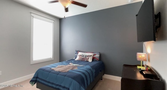 bedroom featuring ceiling fan and baseboards