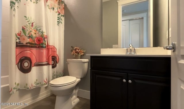 bathroom with shower / bath combo, vanity, toilet, and baseboards