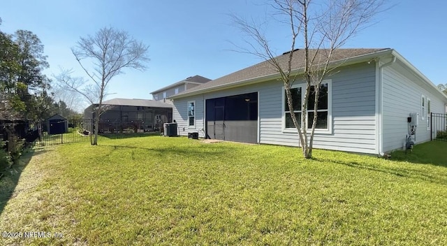 back of house featuring cooling unit, a yard, and fence