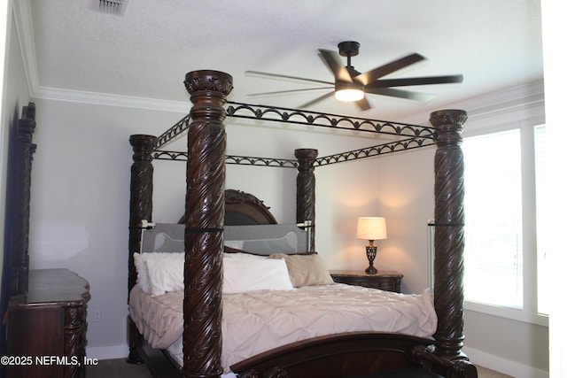 bedroom featuring baseboards, ceiling fan, visible vents, and crown molding