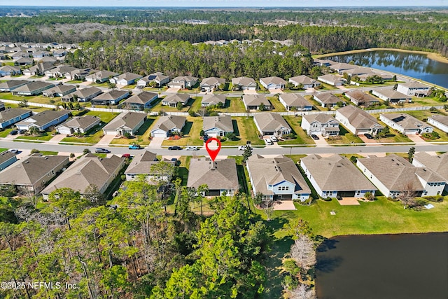 drone / aerial view with a residential view and a water view