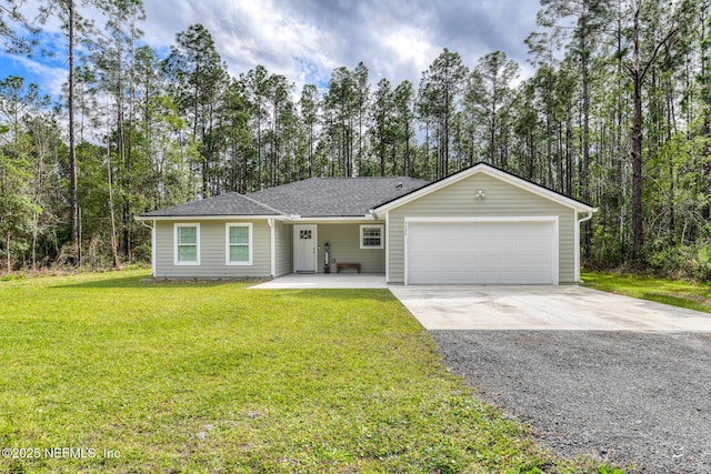 ranch-style home with an attached garage, driveway, and a front yard