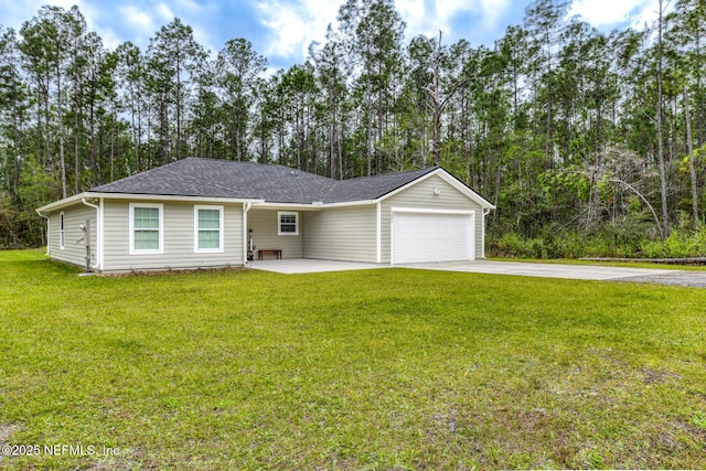 ranch-style home with a garage, concrete driveway, a shingled roof, and a front yard