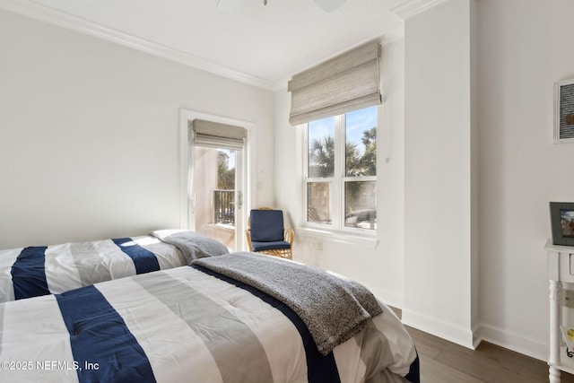 bedroom with dark wood-style flooring, a fireplace, baseboards, access to outside, and crown molding