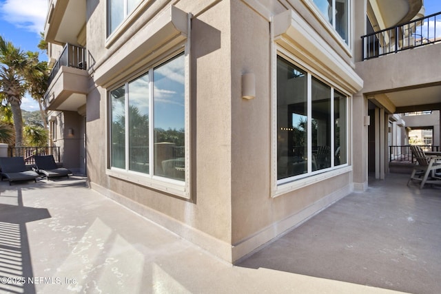 view of home's exterior with a patio area and stucco siding