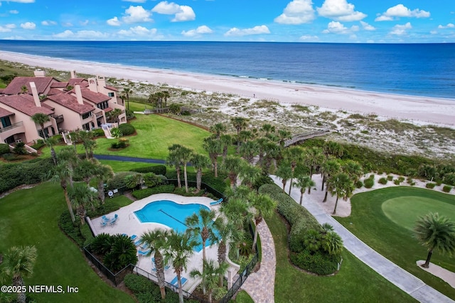 drone / aerial view featuring a water view and a view of the beach