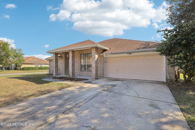 view of front of house with brick siding, a shingled roof, concrete driveway, an attached garage, and a front yard