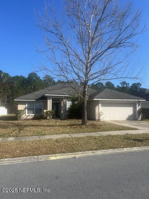 view of front of property with a garage and concrete driveway