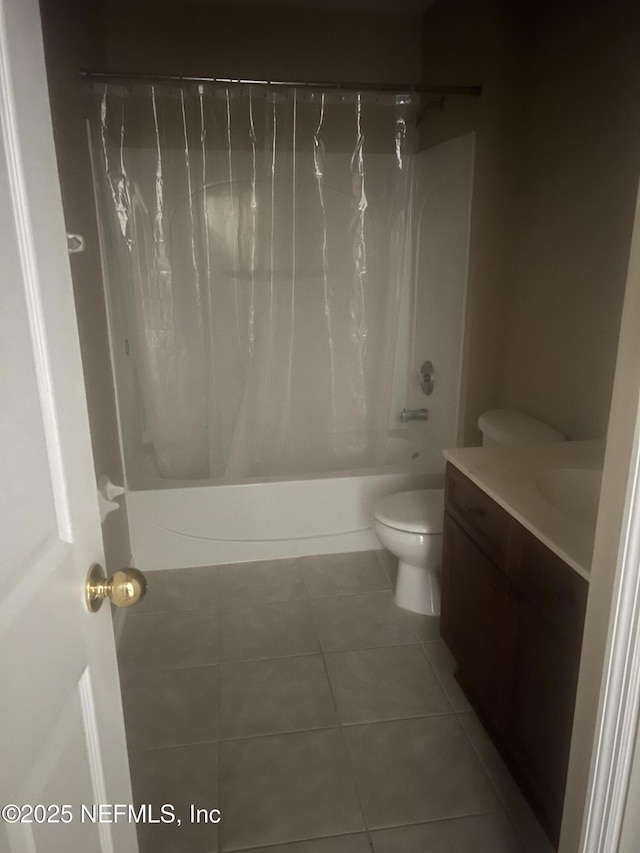 full bath with tile patterned flooring, shower / bathtub combination with curtain, toilet, and vanity