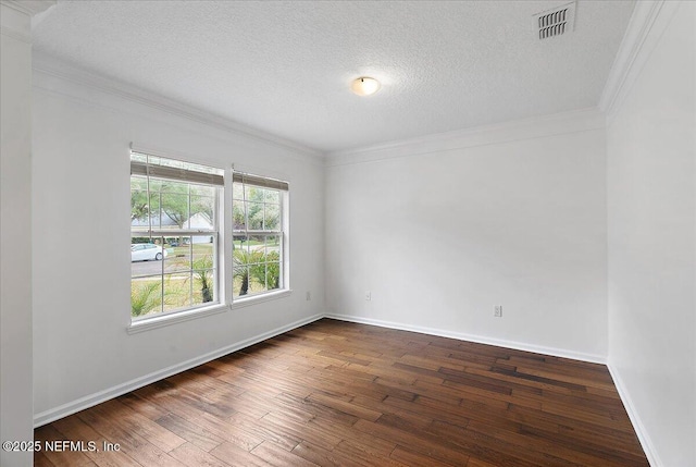 unfurnished room with ornamental molding, dark wood-style flooring, visible vents, and a textured ceiling