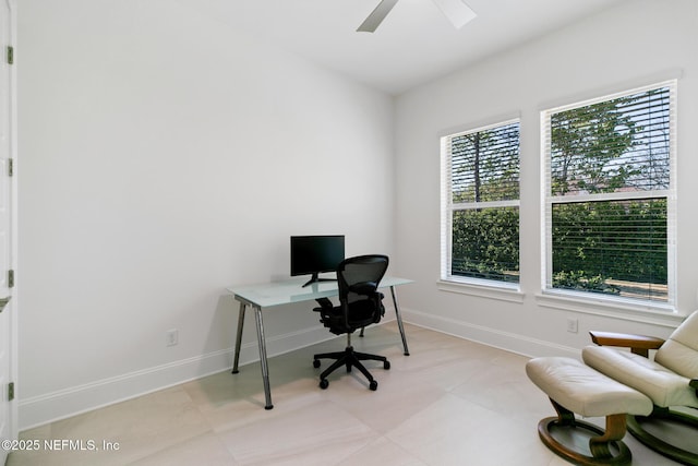 office area featuring ceiling fan and baseboards