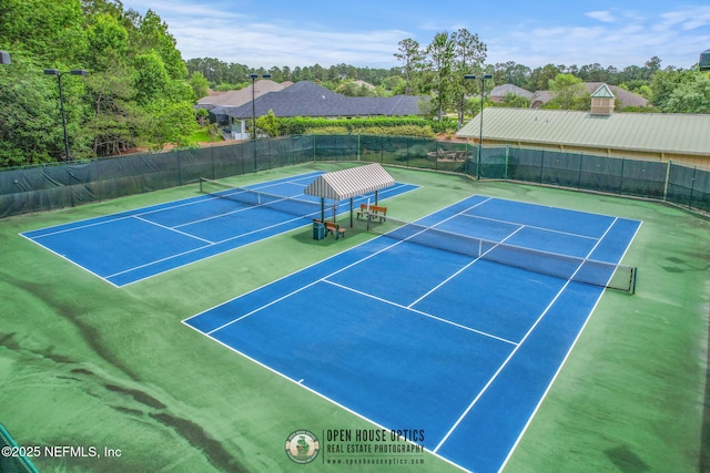 view of sport court with fence