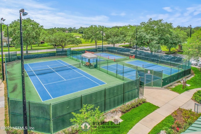 view of tennis court featuring fence