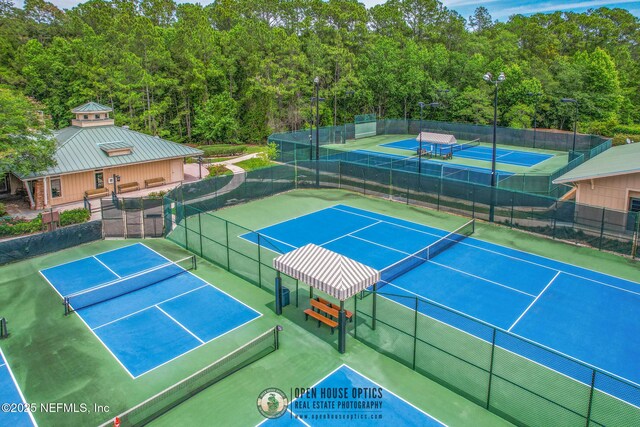 view of tennis court featuring fence