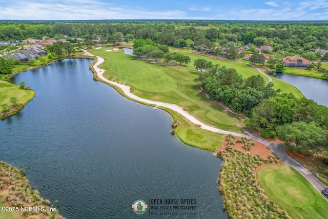 aerial view with a forest view, a water view, and view of golf course