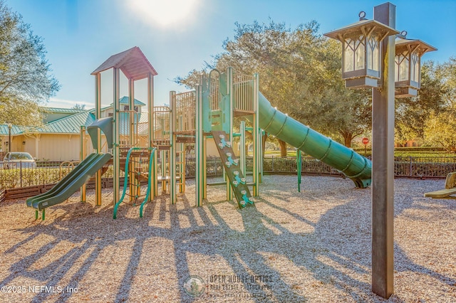 community jungle gym featuring fence