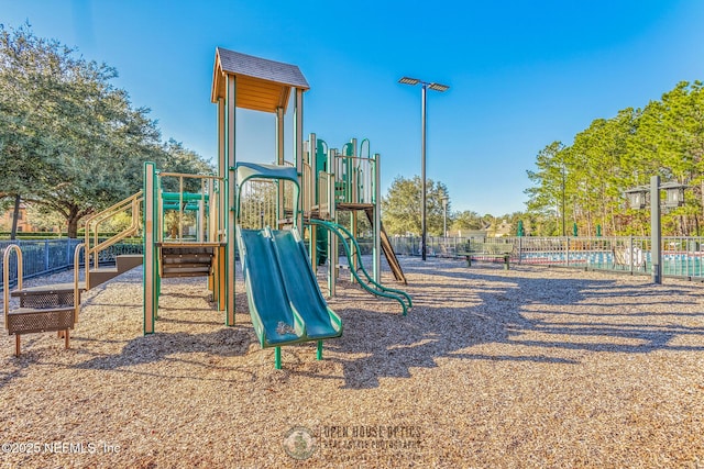 communal playground featuring fence