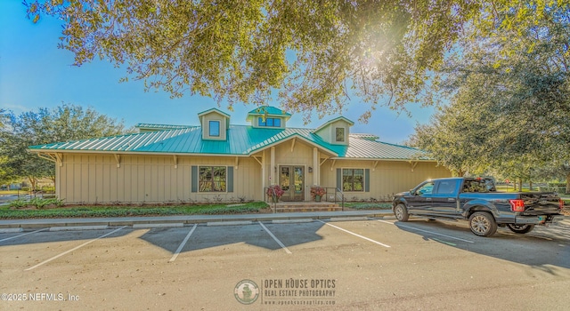 townhome / multi-family property with uncovered parking and metal roof