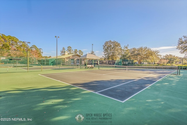 view of sport court featuring fence