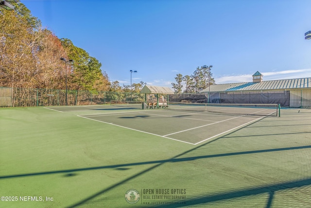 view of tennis court with fence