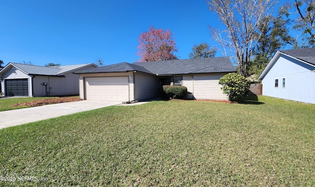 single story home featuring an attached garage, concrete driveway, and a front yard