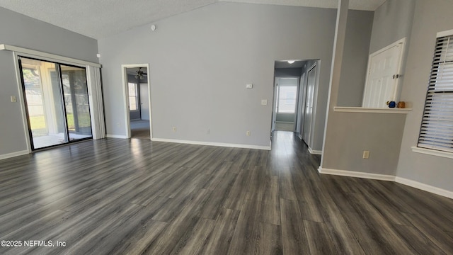 empty room featuring dark wood-type flooring and baseboards