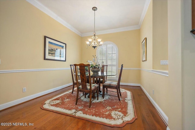 dining area with dark wood-style floors, ornamental molding, and baseboards