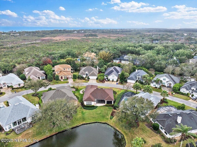 birds eye view of property featuring a water view and a residential view