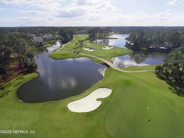 drone / aerial view featuring golf course view and a water view