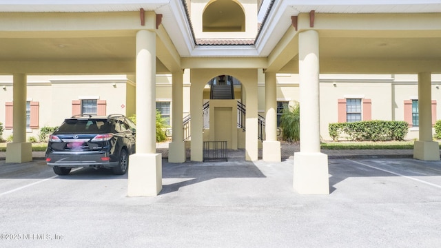 doorway to property featuring covered parking