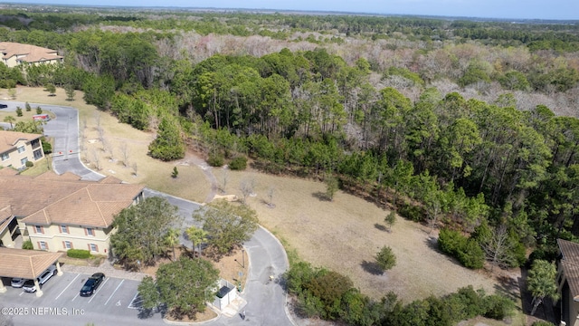 drone / aerial view with a wooded view