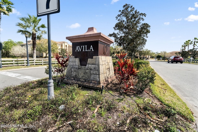 community / neighborhood sign featuring fence