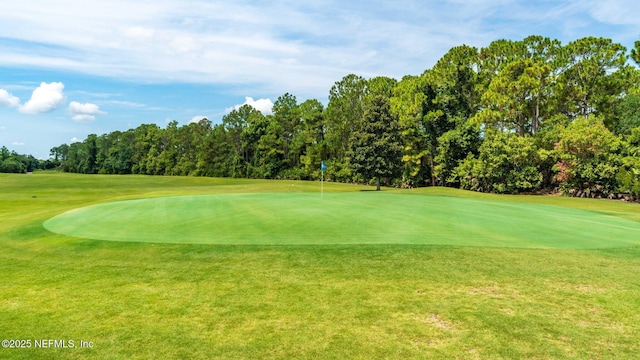 view of home's community with a lawn and golf course view