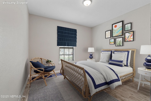 bedroom with wood finished floors and baseboards