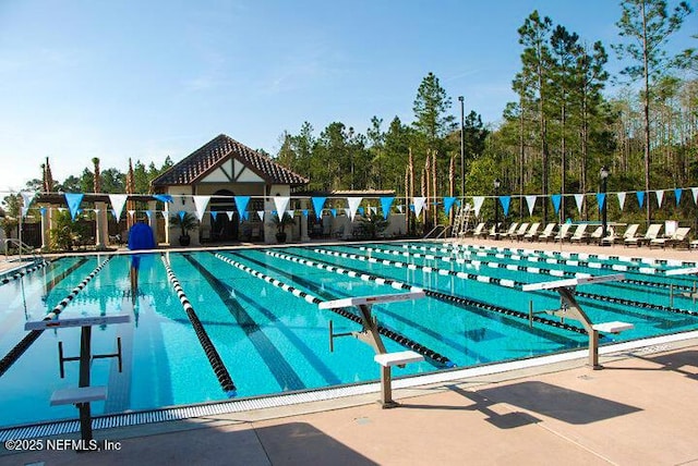 pool featuring fence and a patio