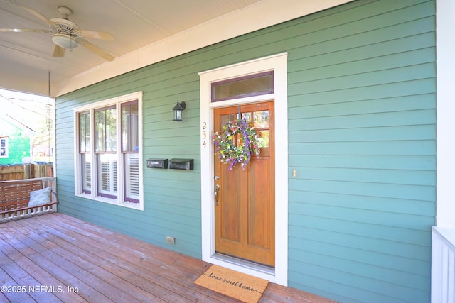 property entrance with a porch and ceiling fan