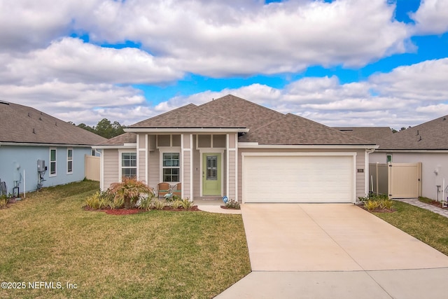 ranch-style house with a garage, concrete driveway, roof with shingles, fence, and a front yard