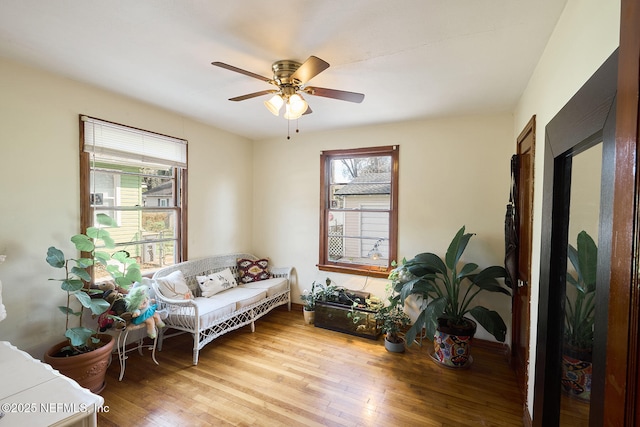 sitting room featuring light wood-style floors, ceiling fan, and baseboards