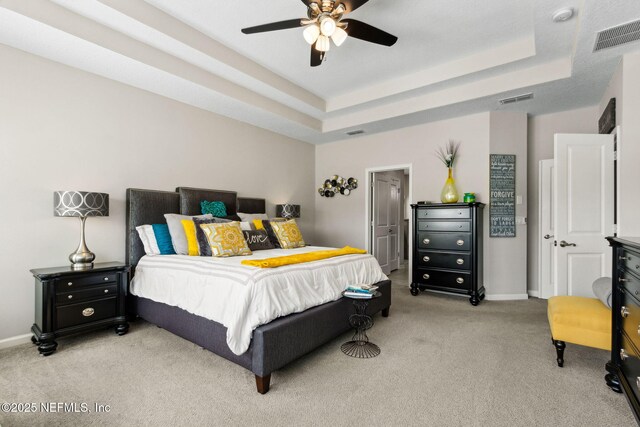 986 Prairie Dunes Ct, Orange Park, FL 32065 - bedroom featuring visible vents, light carpet, and a raised ceiling