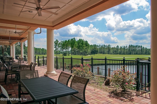 986 Prairie Dunes Ct, Orange Park, FL 32065 - view of patio featuring fence, view of golf course, outdoor dining space, a water view, and ceiling fan
