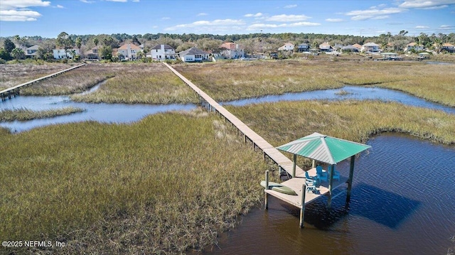 bird's eye view with a water view and a residential view